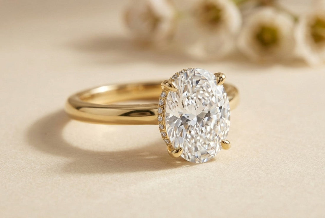 Oval diamond hidden halo engagement ring in 14K yellow gold with a plain polished band