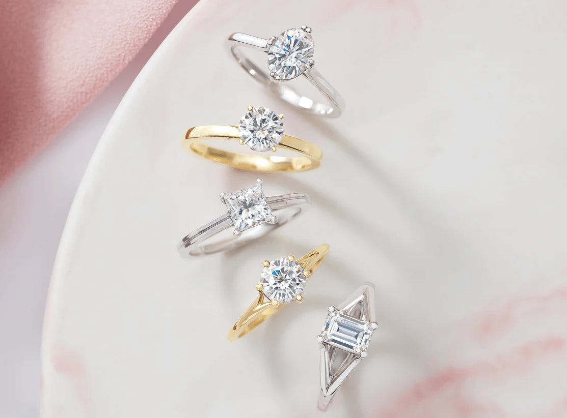 Custom solitaire engagement ring with a modern bezel setting and personalized diamond choice.