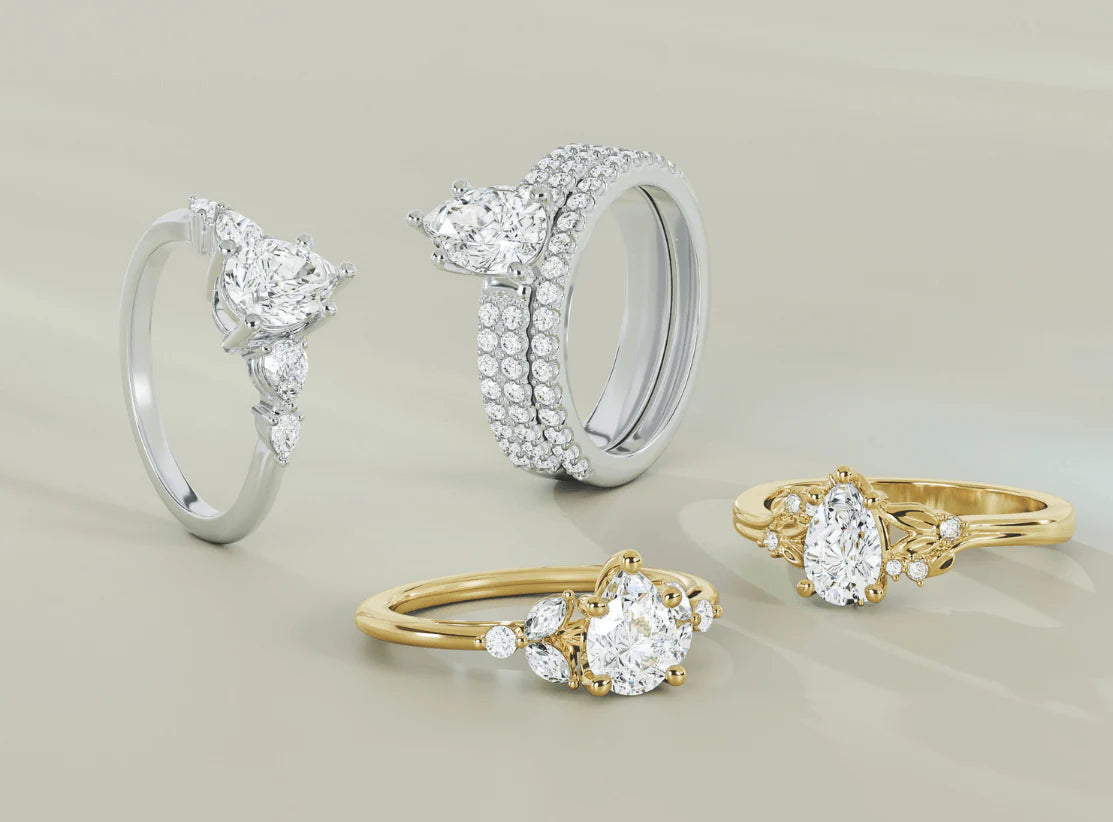 Personalized engagement ring with unique side stone arrangements including marquise petals and graduating diamonds.